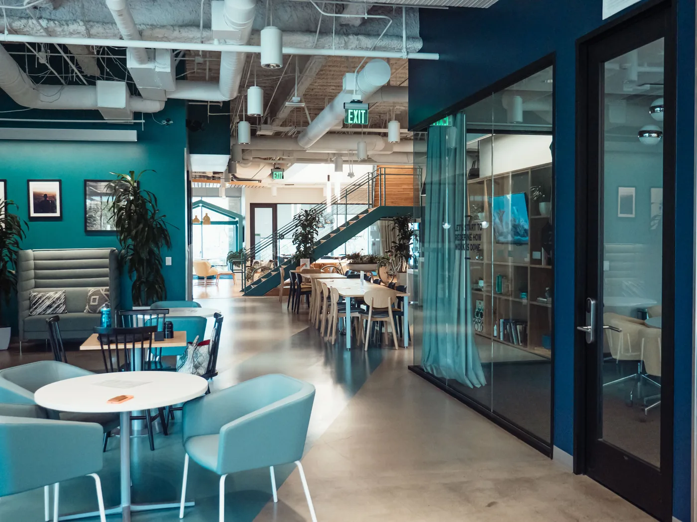 Lounge seating beside glass meeting rooms